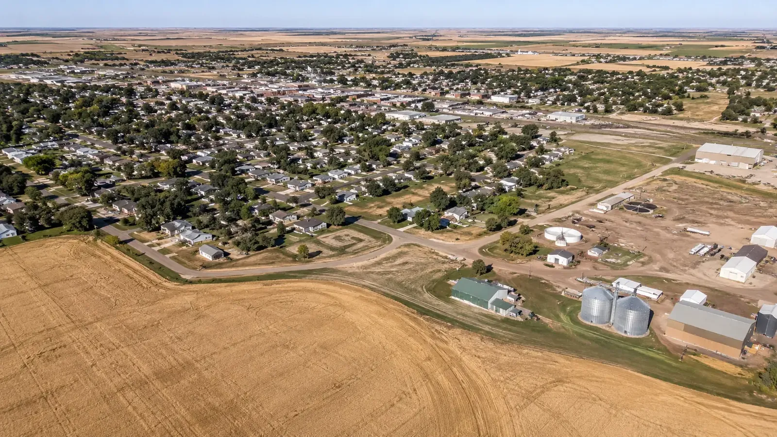 Aerial view of Sidney, Nebraska surrounded by farmland and grain bins
